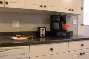a kitchen counter with a coffee maker on a counter top at Hiltz House Cellar Suite Near Halifax Ferry in Halifax
