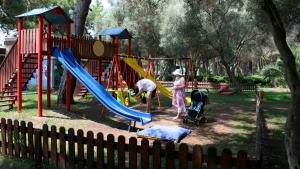 a group of people playing in a playground at Denizati Holiday Village in Gumuldur