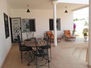 a dining room with a table and chairs at Keur Baboune in Mbour