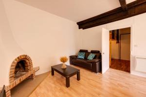 a living room with a couch and a fireplace at La Terrasse du Thiou - Location in Annecy