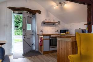 a kitchen with a sink and a counter top at The Granary in Bryn-crug