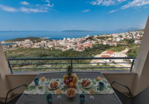 a table with a plate of food on a balcony at Seaview apartments Oscar in Makarska