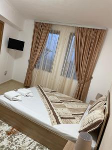 a bed in a room with a large window at Гранд Манастира , Пампорово in Pamporovo