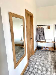 a dressing room with a mirror and a table at NEW! Country boutique escape . HOT TUB in Weare Giffard