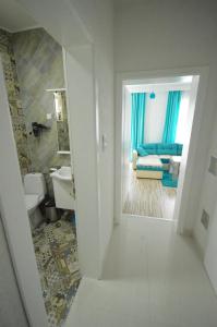 a view of a bathroom with a sink and a living room at Antonio Apartments in Ohrid