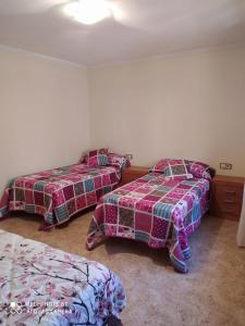 1 dormitorio con 2 camas y una falda en Les Fonts en Cabacés