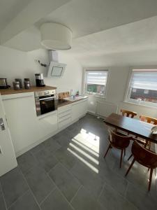 a kitchen with a table and a dining room at Fernweh Harz in Seesen