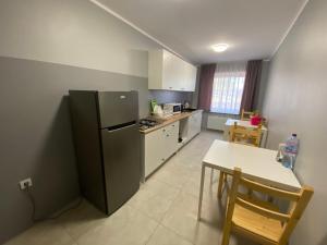 a kitchen with a black refrigerator and a table at Hotelik Nad Zalewem 10 km od Legnicy in Legnica