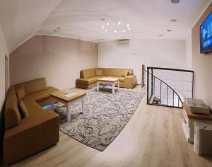 a living room with two couches and a tv at Relax Lounge in Velké Meziříčí
