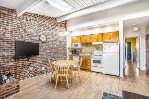 a kitchen with a table and a brick wall at Cottage by the Sea in Gearhart