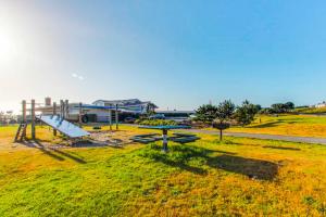 a park with a playground with a slide at Cottage by the Sea in Gearhart +10 photos