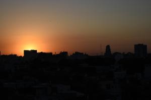 a silhouette of a city with the sunset in the background at Palermo Soho. Moderno, Cómodo y Luminoso in Buenos Aires