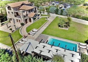 an aerial view of a house with a swimming pool at Palazzo Di P Villa, World 5th Award in Kalpaki