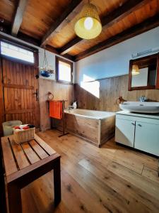 a large bathroom with a tub and a sink at Maison des Isard in Saint-Pierre-dels-Forcats