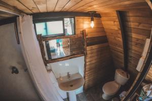 an overhead view of a bathroom with a sink and a window at Cardinal Glamping in Guatapé