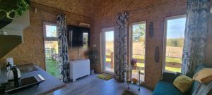 a living room with large windows and a couch at One House in Chojna