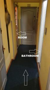 a hallway with a room and a door labelled bathroom at "hotel30" ROOMS in the centrum -free garage parking in Budapest