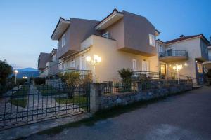 a large house with lights on the side of it at Remvi Hotel - Apartments in Stoupa