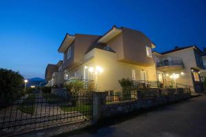 a large house with lights on the side of it at Remvi Hotel - Apartments in Stoupa