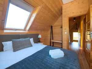 a bedroom with a large bed in a wooden cabin at Dziadkowka in Gliczarów