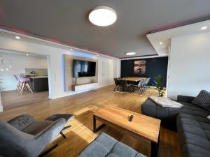 a living room with a couch and a table at Ferienhaus LEMA in Schopfloch