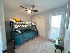 a bedroom with a bunk bed and a ceiling fan at The Burque Boho House in Albuquerque