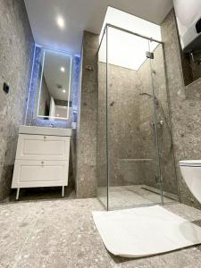 a bathroom with a glass shower and a sink at Premium Apartmani Banja Luka in Banja Luka