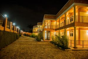 a cobblestone street in front of a building at night at IGITEGO APARTHOTEL LTD in Kigali