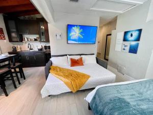 a bedroom with a bed with an orange blanket on it at Central Studio in Historic Miami in Miami