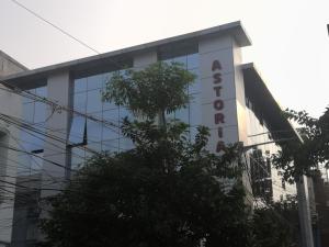 a building with a sign on the side of it at Astoria Hotel in Kolkata
