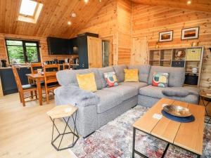 a living room with a couch and a table at Castle View Lodge in Derby