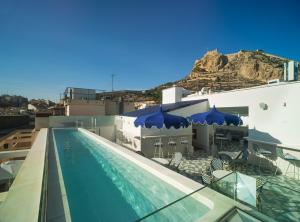 a swimming pool on the roof of a building at Dormirdcine Alicante in Alicante