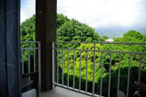 a room with a balcony with a view of trees at GK Luxury Apartment in Kingston