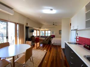 a kitchen and living room with a table and a bed at Redrock Retreat in Kingaroy