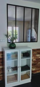 a white cabinet with a vase on top of it at Villa Les oliviers in Le Pontet