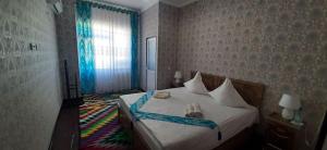 a bedroom with a bed with shoes on it at Guest House Art Postindoz in Khiva +115 photos