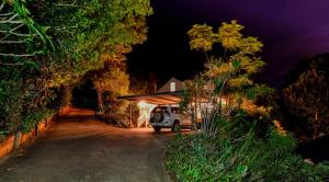 a van parked in front of a garage at night at Doomben Ridge Accommodation in Beechmont