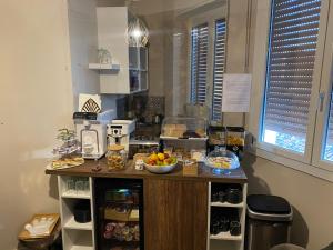 a kitchen with a counter with a bowl of fruit on it at SUITE LAME & stay comfy in Bologna