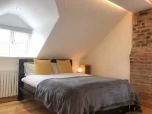 a bedroom with a large bed in a attic at The Manor Barn in Northampton