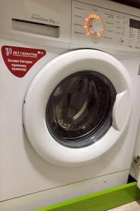 a white washing machine with its door open at Квартира в центре (р-н Аян Пассаж) in Temirtaū