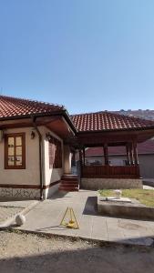 a house with a yellow sign in front of it at MON Accommodation free parking in Niš