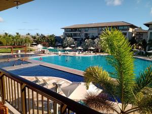 a view of the pool from the balcony of a resort at Portoparadise - Beach Class Eco life Residence in Porto De Galinhas
