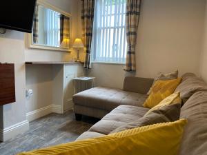 a living room with a couch and a window at Brampton Holiday Homes - Beckside Apartment in Brampton