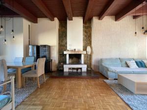 a living room with a couch and a table at Wellness Villa Totina in Liptovský Mikuláš – Demänová