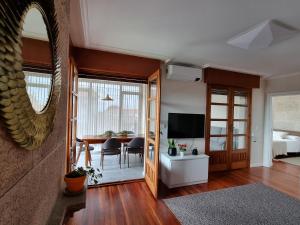 a living room with a table and a mirror at Apartamentos Ria de Aldan in Aldán