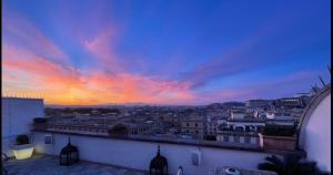 a view of a city at sunset from a balcony at Penthouseinrome in Rome +8 photos