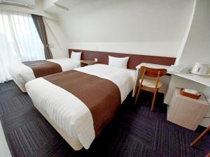 Tempat tidur dalam kamar di Akasaka Urban Hotel