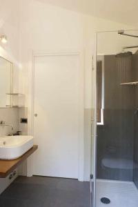 a bathroom with a glass shower and a sink at San Venanzo - Casale de Conti in San Venanzo