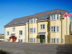 a large yellow building with a person standing in front of it at 5 Porth Gwel in Falmouth