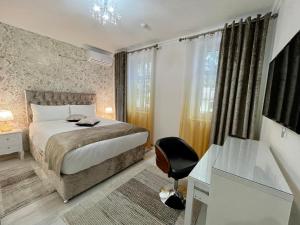 เตียงในห้องที่ Premier City Apart Hotel Chisinau